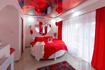 Intewrior of a romantic red hotel bedroom
