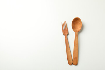 Wooden spoon and knife on white background, space for text