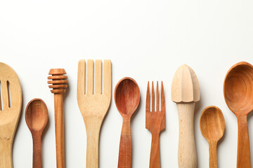 Different wooden dishes on white background, space for text