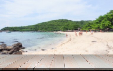 Fototapeta premium Wood perspective on blue sea and beach blur image background. wood table top on blurred blue sea. thai sea concept.