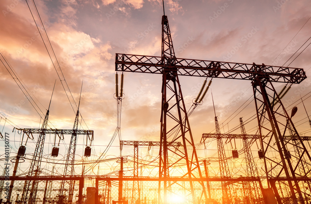 Wall mural distribution electric substation with power lines silhouette on the dramatic sunset background