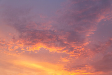 Naklejka na ściany i meble Bright sunset sky with clouds and sunbeams.