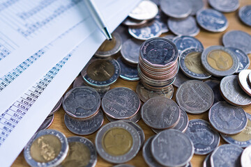 Future plan saving money for 2021 year concept. Coin with document on on wood background.