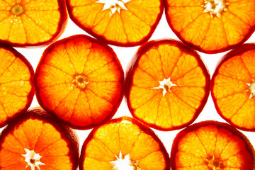 Silhouettes. Colorful creative background of citrus: mandarin slices. Flat lay macro close-up, top view