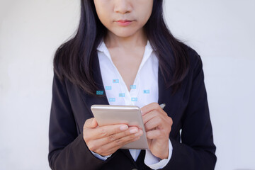 Close up staff business woman with black  suit using mobile with icon Envelope, heart shaped, dollar symbol, euro symbol on white background. She is working