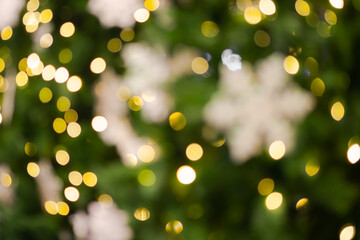 Fototapeta na wymiar Gold yellow and white bokeh with blur snowflakes abstract background. for add text or image product presentation or for merry christmas and happy new year background.