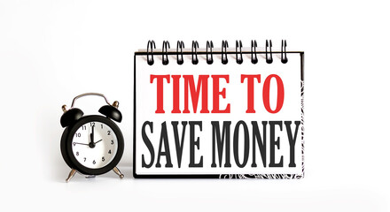 TIME TO SAVE MONEY notepad writing on white background with alarm clock