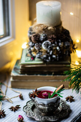Warm, cozy Christmas atmosphere. A cup of tea with spices. Bokeh style