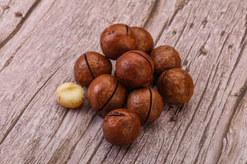 Brown macadamia nut heap over background