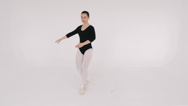 Isolated ballerin woman is dancing in white studio. Hobby, passion.