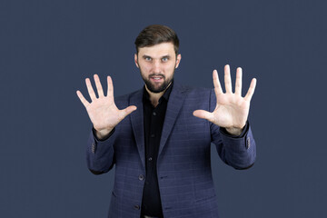 a male businessman in a blue suit shows his hands