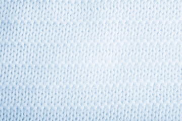 Close up of blue knitted textured background. Trendy color.