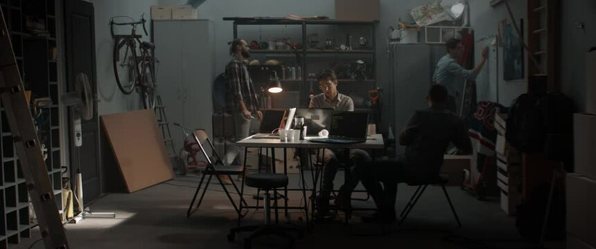 WIDE Young people having heated argument during brainstorm. Launching their small IT business startup company from garage. Shot with 2x anamorphic lens