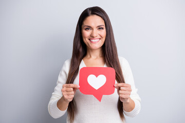 Photo of mature beautiful happy positive good mood woman holding heart icon isolated on grey color background