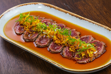 Beef tartare with sauce and herbs