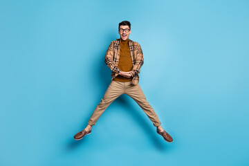 Full size photo of young excited crazy positive shocked amazed man jumping see sale discount isolated on blue color background