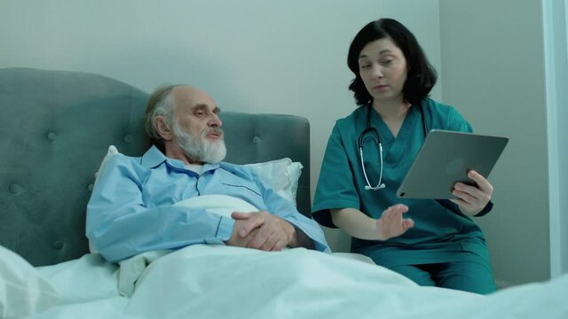 Doctor showing to patient analysis results on tablet, modern technology, clinic