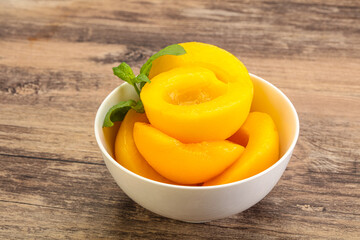 Sweet ripe canned peaches with mint