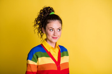 Photo of lovely shy lady look ashamed side empty space tricky wear rainbow sweater isolated yellow color background