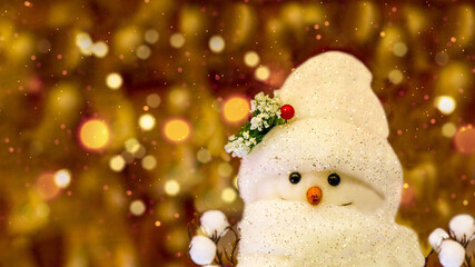 Toy Snowman, on the background of Christmas lights