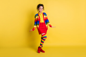 Full length body size view of pretty cheerful wavy-haired wear cosy garment posing isolated bright yellow color background