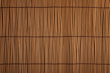Sushi roll bamboo mat surface close up photo for background.