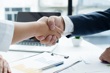 The businessmen shake hands after the meeting was successful and agreed upon