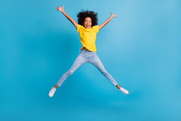 Full length photo of cheerful afro american brunette girl jump star shape raise hands wear casual...