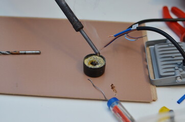 The master soldering iron solders the wires.