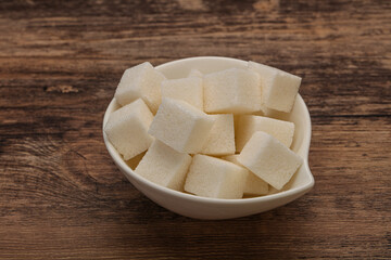 Refined white sugar cubs in the bowl