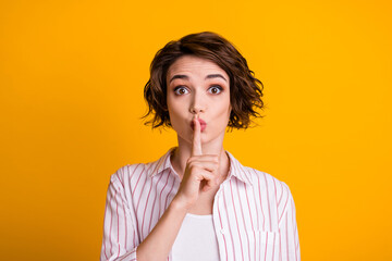 Photo of surprised girl dont want share secret put index finger lips keep taboo silence wear good...