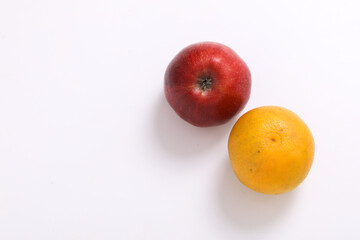 Red apple and orange or mosambi fruit on white background