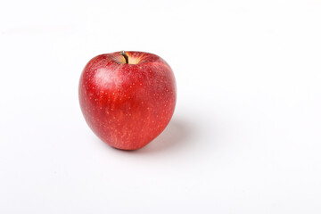 Water drop on fresh red apple on white background