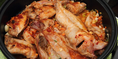 Rabbit fried in a pan with carrot and onion