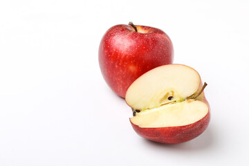 Red apple with half slice on white background