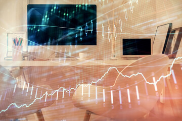 Double exposure of stock market graph drawing and office interior background. Concept of financial analysis.