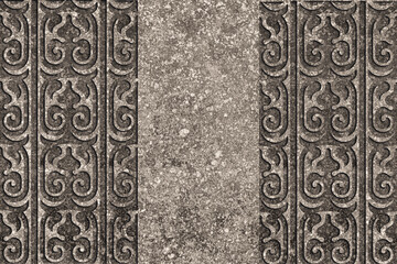 Ornamental print on the granite surface. Vintage ornament on the stone. Embossed drawing. Close-up. Stone texture. Pattern on the stone. Embossed pattern. Wallpaper. Tile. Close-up of seamless texture