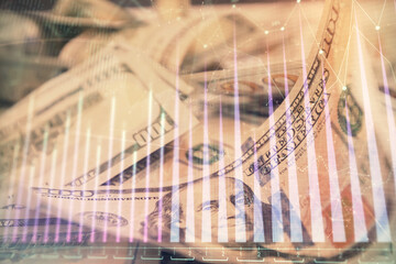 Double exposure of forex graph drawing over us dollars bill background. Concept of financial markets.