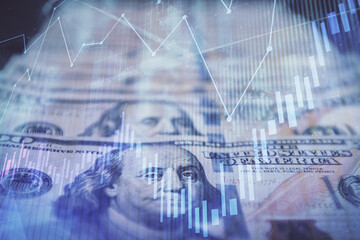 Double exposure of forex graph drawing over us dollars bill background. Concept of financial markets.