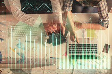 Double exposure of man and woman working together and financial graph hologram drawing. market...