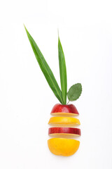 Stack of fresh fruits citrus slices, apple, orange or lemon. Colorful healthy fitness creative fun food concept. Mixed citrus fruit, apple isolated on white background