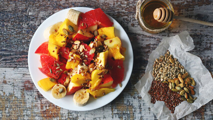 Healthy fruit salad with mango and seeds.