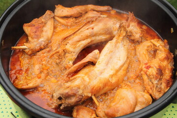 Rabbit fried in a pan with carrot and onion