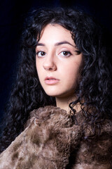 Beautiful woman  with a fur blanket on black background