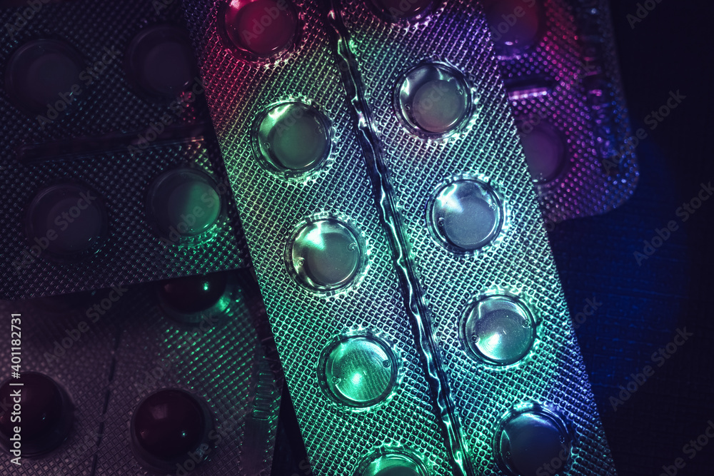 Poster pills or drugs in a package under neon light on a dark background pattern for design..