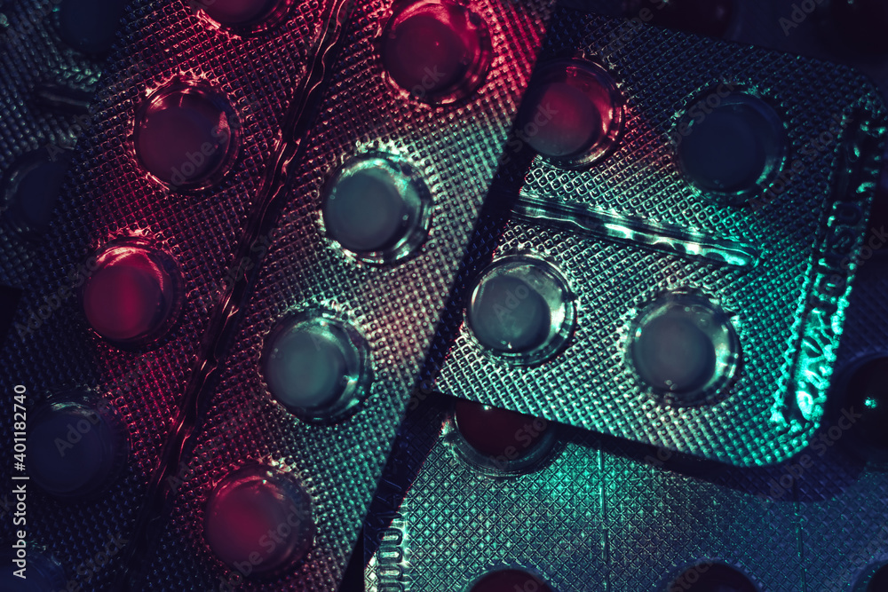 Poster pills or drugs in a package under neon light on a dark background pattern for design..