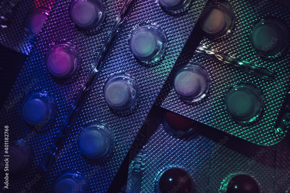 Poster pills or drugs in a package under neon light on a dark background pattern for design..