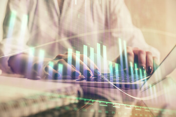 Double exposure of woman hands typing on computer and forex chart hologram drawing. Stock market invest concept.