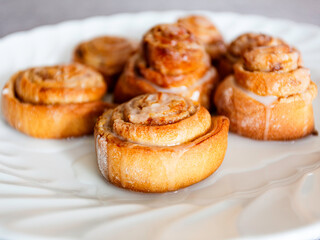 Close up sweet homemade cinnamon rolls on white plate