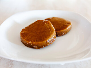 Seitan to be cooked in a white dish. Vegan, high-protein, gluten-derived ingredient in wheat, soft or spelt or khorasan